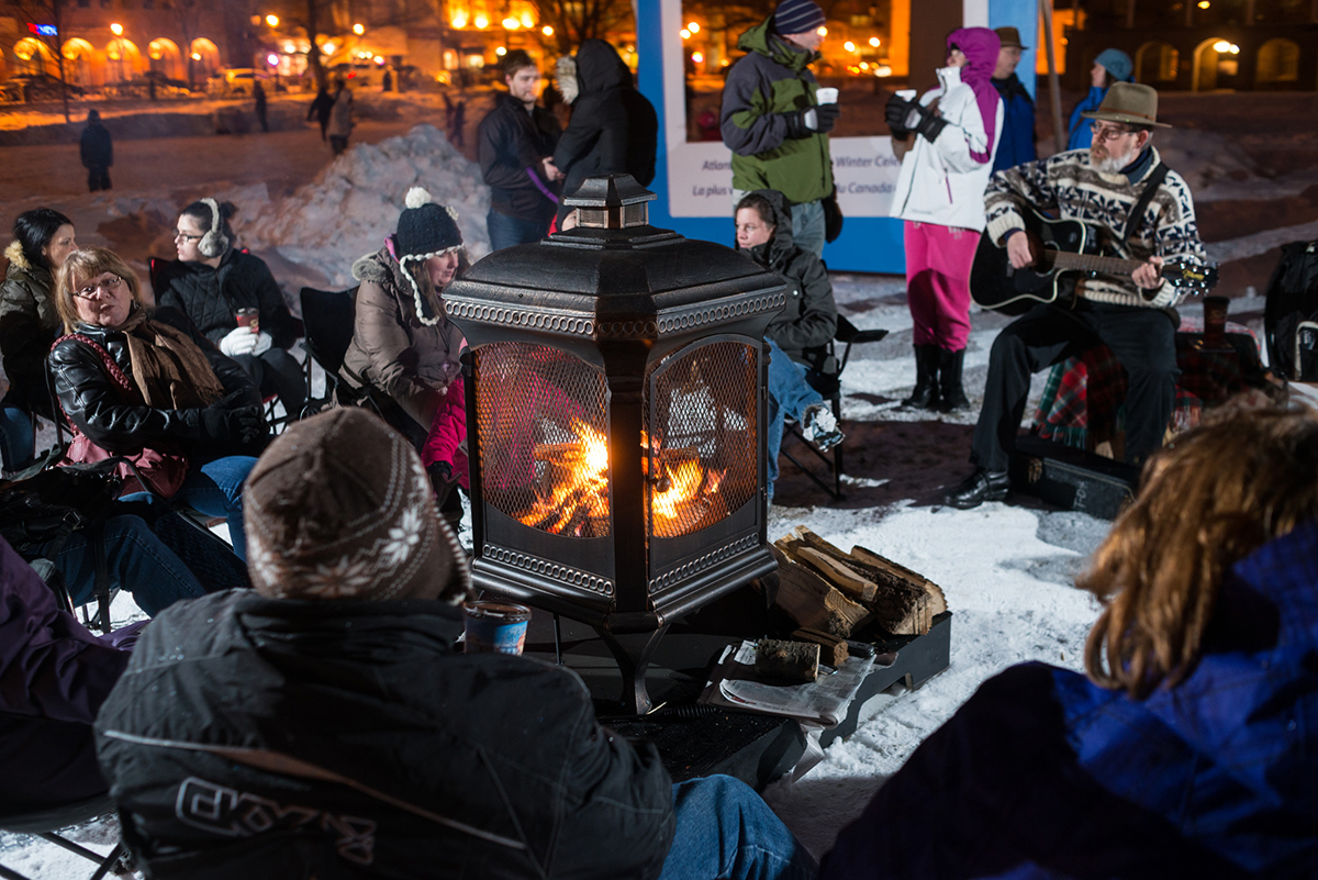 Photo of people around outdoor fire in winter